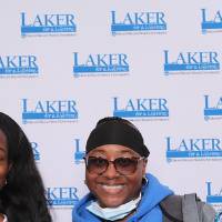 two alumni posing together and smiling